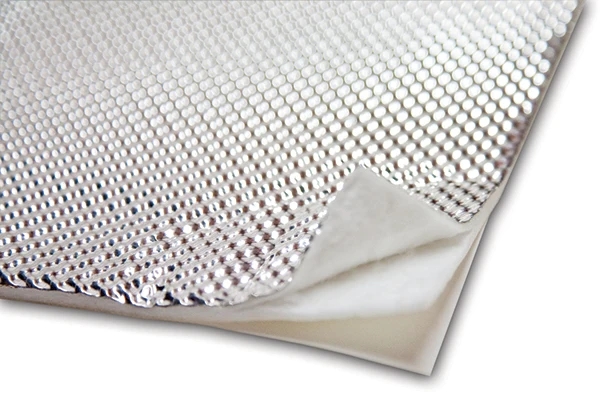 Peel and stick heat shield installed on automotive firewall Peel and stick heat shield installed on automotive firewall